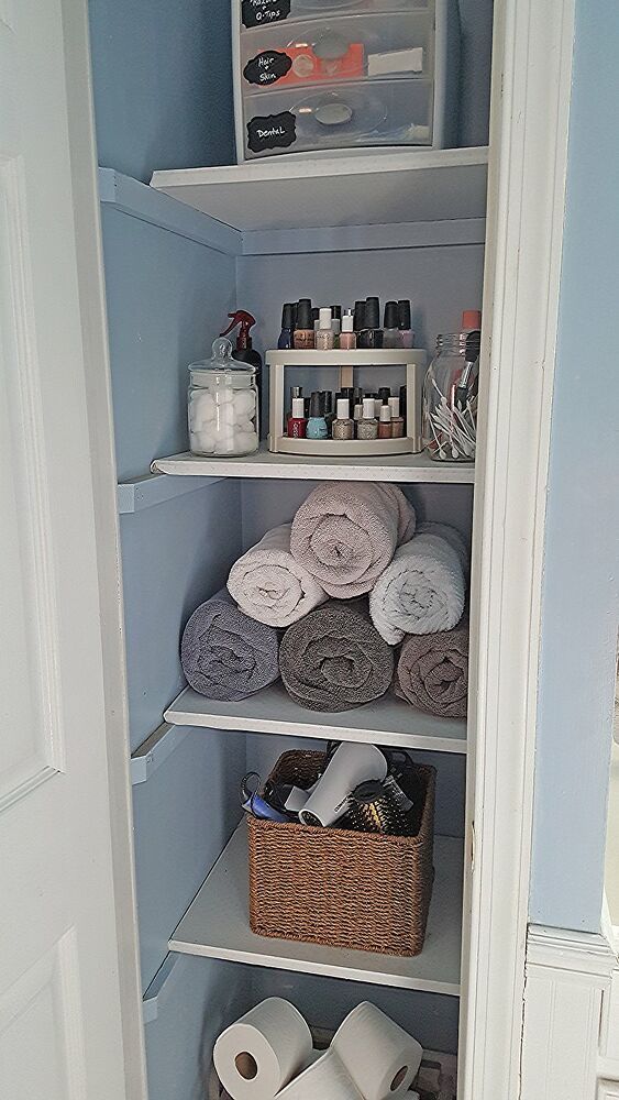 an organized closet with toilet paper and other items