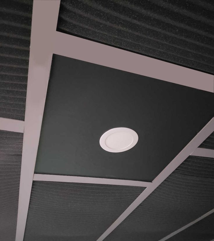 the ceiling is covered in black and white paper with a circular light fixture on it