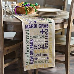 the table is set with plates, glasses and a basket of candy on top of it