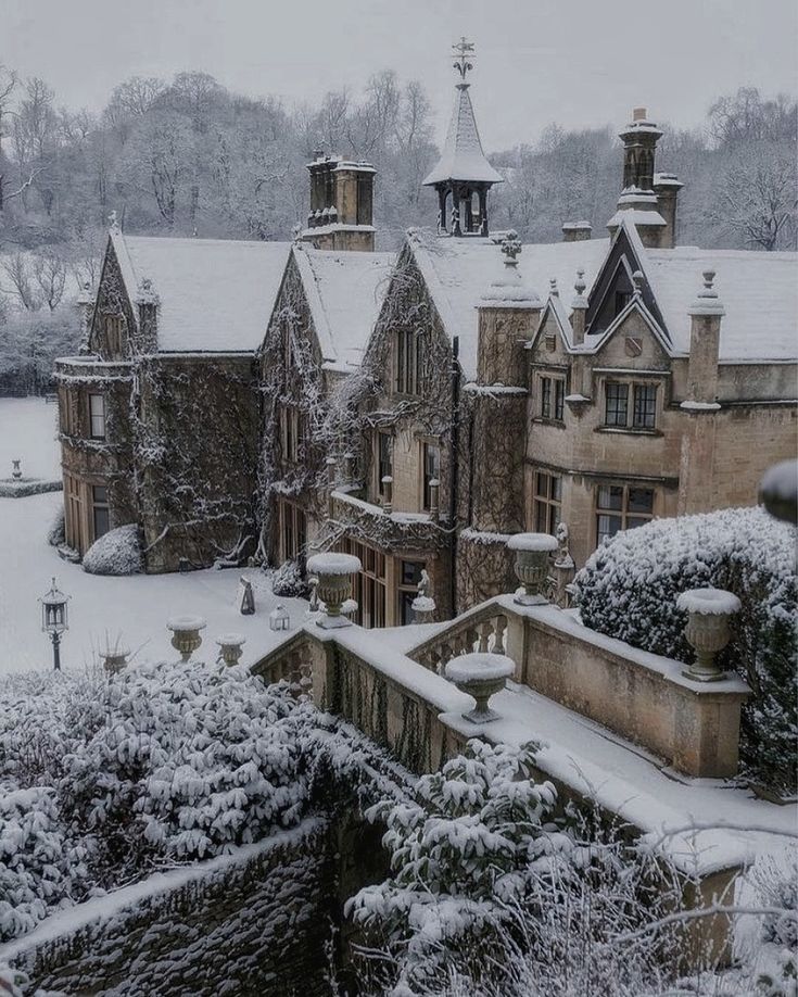 a large building with many windows and towers covered in snow