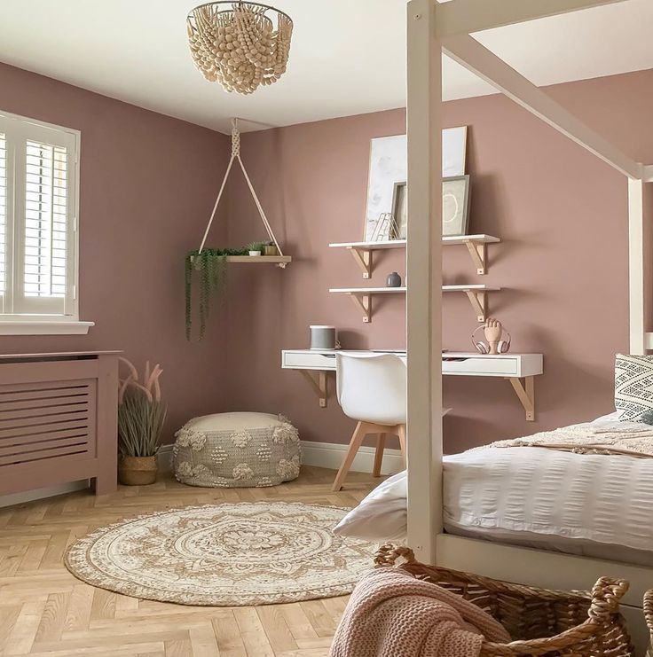 a bedroom with pink walls and white furniture