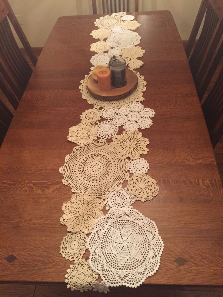 the table runner is made from crocheted doily