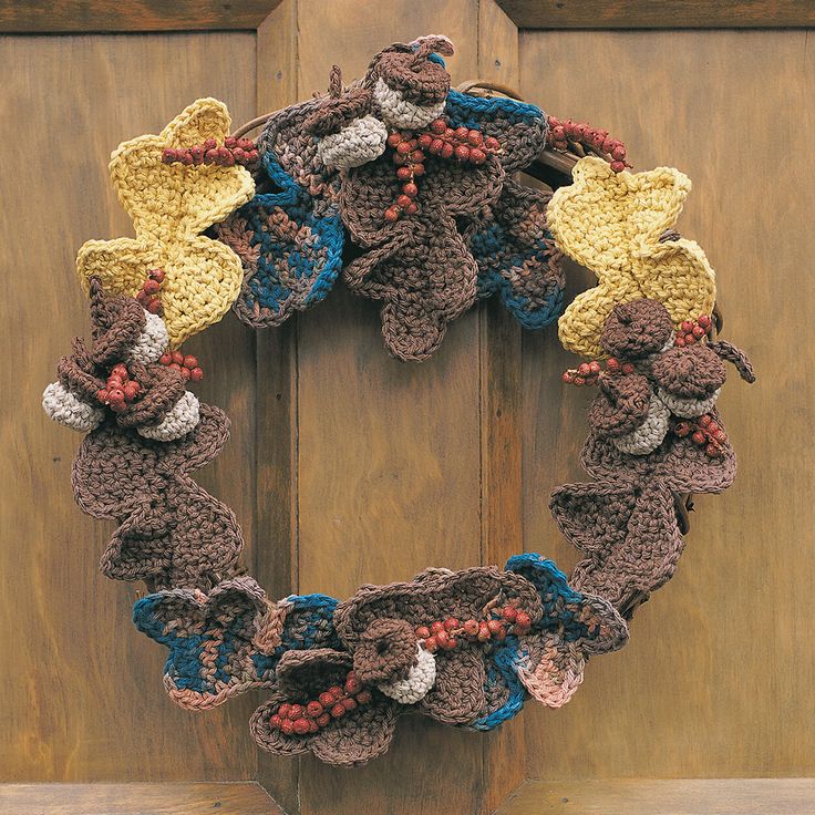 a crocheted wreath hanging on the front door