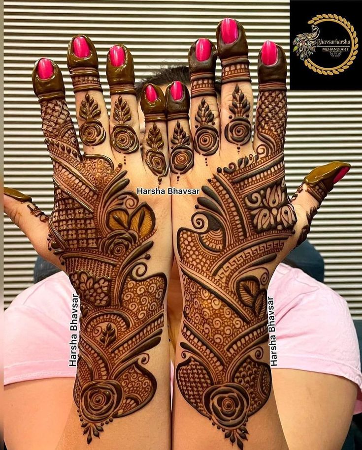 a woman's hands with henna tattoos on them