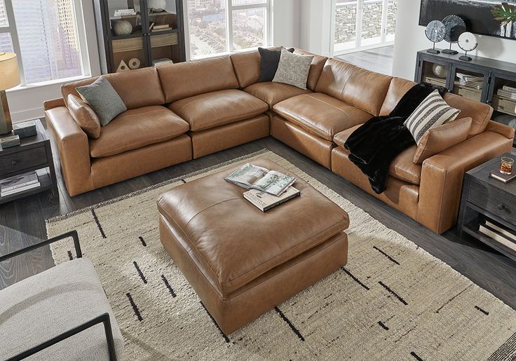 a living room filled with lots of furniture in it's centerpiece and windows