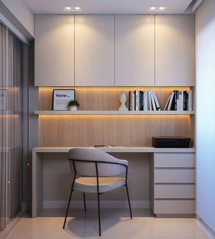 a chair sitting in front of a desk with books on top of it next to a book shelf