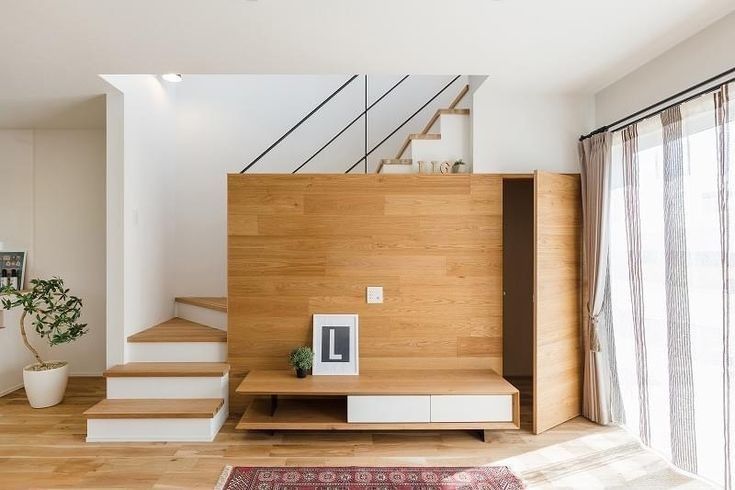 a living room with wooden floors and stairs