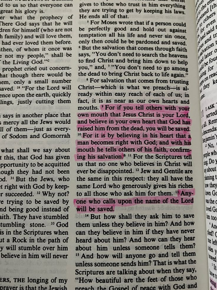 an open book with pink and black text on it's page, which has been altered to read the bible