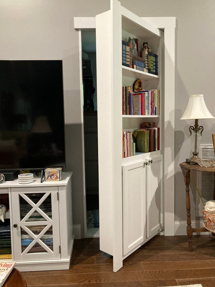 a living room with bookshelves and a television