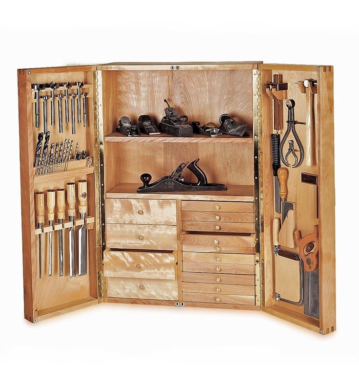 an open wooden tool cabinet filled with lots of tools