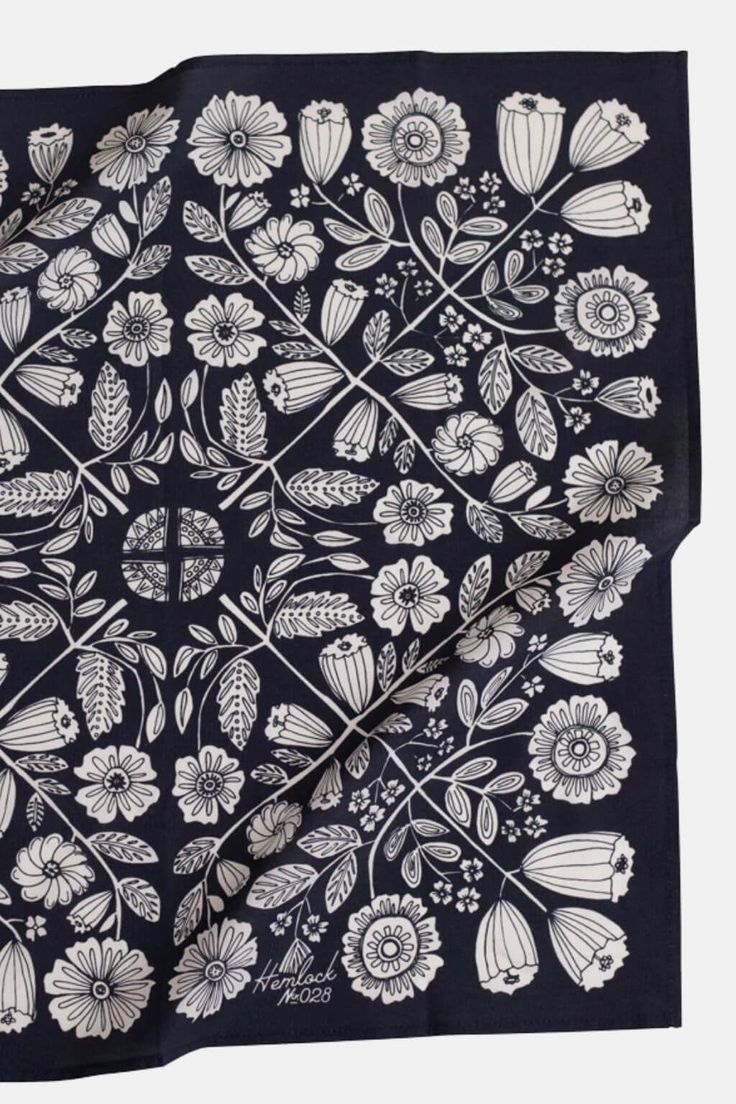 a black bandana with white flowers on it