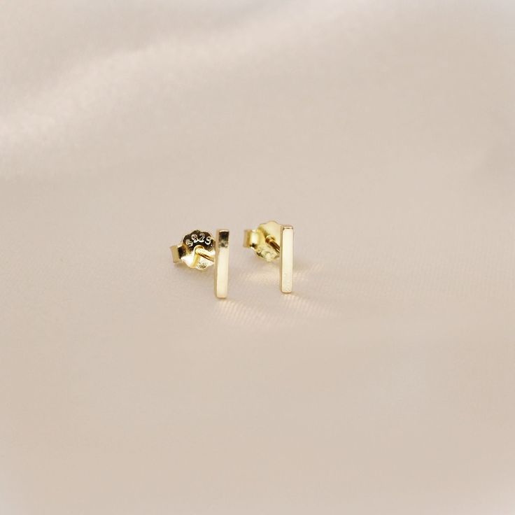 Simple Bar Stud Earrings- This listing is for a pair of the Bar Stud Earring. A perfect everyday piece to be worn alone or great layered with each other.- Base Material: High Quality Solid 925 Sterling Silver- Finish: 18K Gold or Rhodium- Measurement: 6mm - Nickel Free- All our jewelry is packaged in gift ready boxes. If you would like multiple items from your order packaged separately please let us know!© 2023 Generation of Daughters Lingot D'or, Gold Bar Earrings Studs, Bar Stud Earrings, Bar Studs, Stud Jewelry, Gold Bar, Stud Earring, Jewelry Earrings Studs, Solid 925 Sterling Silver