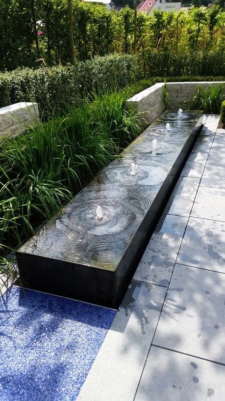 a water feature in the middle of a garden