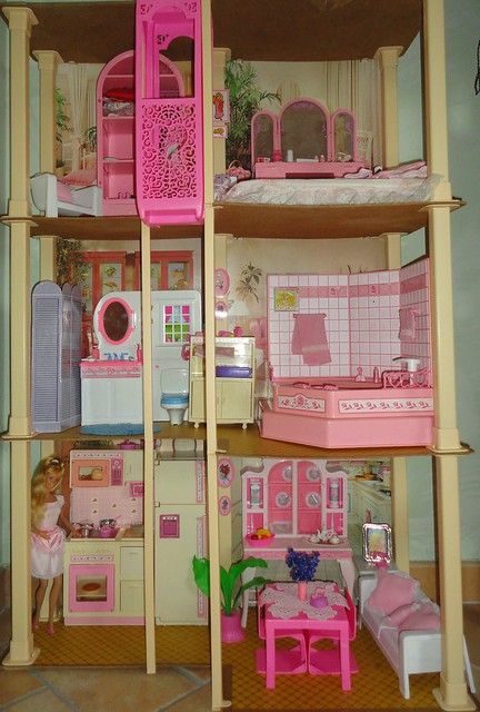 a doll house with pink furniture and accessories