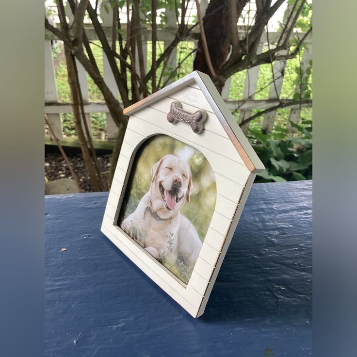 a white dog in a house frame with a bone on it