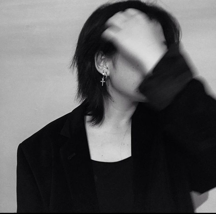 black and white photograph of a woman with her hands in the air while wearing earrings