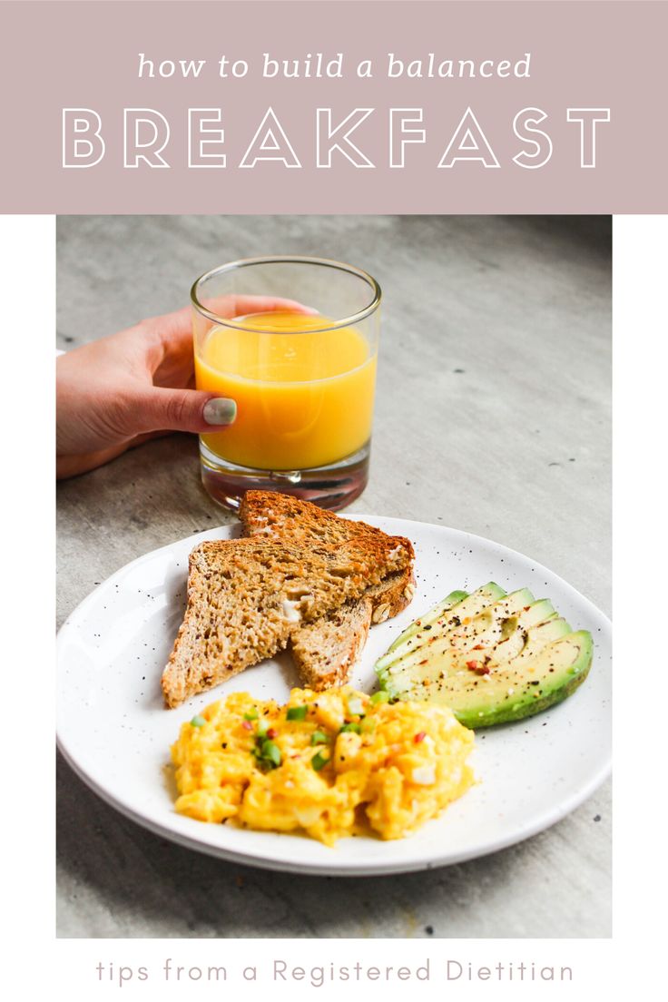 a white plate topped with eggs and toast next to a glass of orange juice