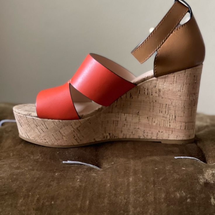 The Brand New Coach Isla Cork Platform Wedge Sandals Are Sure To Catch Some Double Takes With This Red/Orange And Brown Two Tone Color Blocking. Perfect For The Summer Time, These Are A Win For You Wardrobe! True To Size And Extremely Comfortable! New Without Box Orange Leather Sandals With Heel Loop, Orange Platform Sandals With Ankle Strap, Spring Wedge Sandals With Red Sole, Orange Leather Heels With Heel Loop, Chic Wedge Sandals With Red Sole And Round Toe, Orange Leather Platform Sandals, Casual Wedge Sandals With Red Sole And High Heel, Casual Wedge Sandals With High Heel And Red Sole, Casual High Heel Wedge Sandals With Red Sole