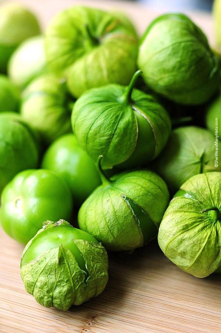 some green peppers sitting on top of a wooden table