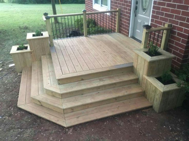 a wooden deck with planters on it