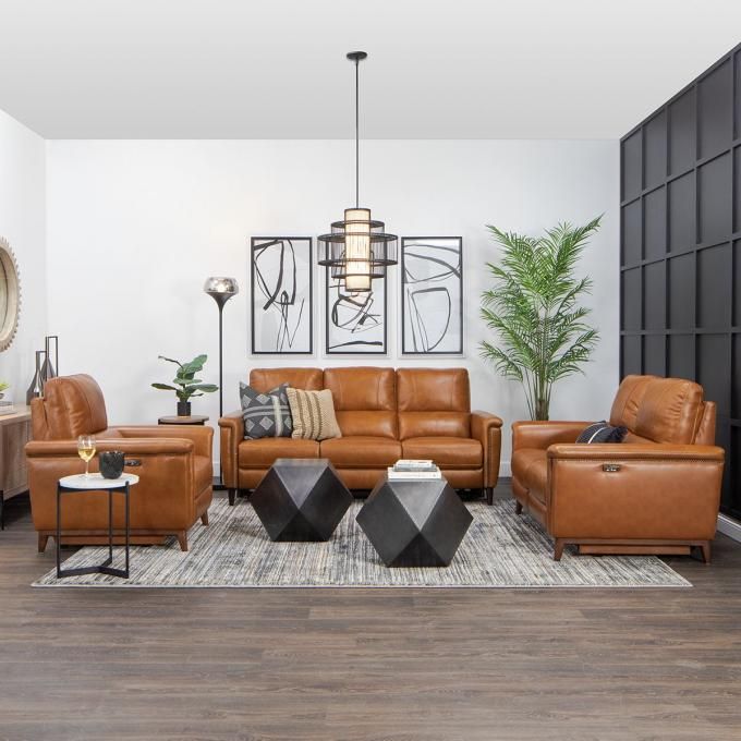 a living room filled with lots of brown furniture