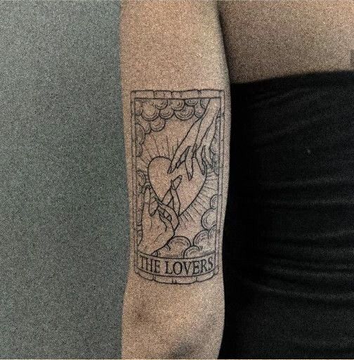 a woman with a tattoo on her arm that reads, the lovers and an image of a dove