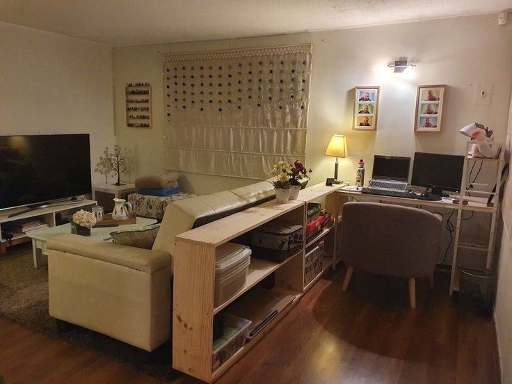 a living room filled with furniture and a flat screen tv sitting on top of a hard wood floor