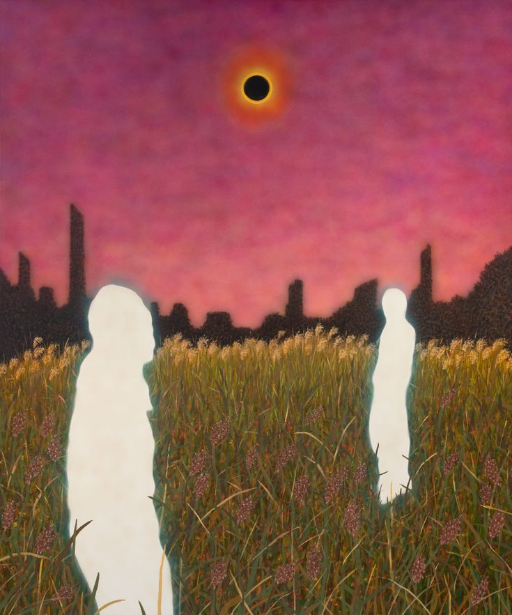 two people standing in the middle of a field at sunset with an eclipse behind them