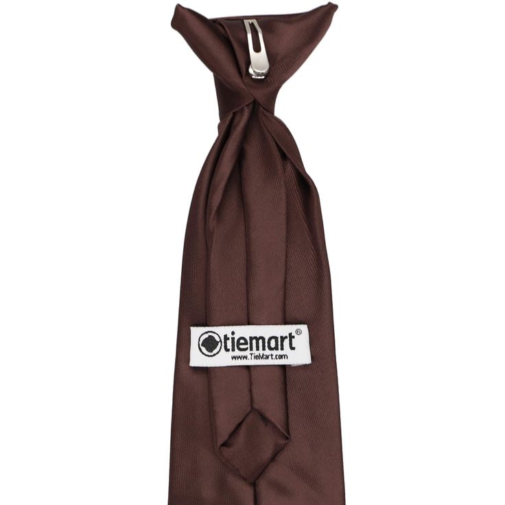 This boys' brown clip-on tie is pre-tied and easy to use with no material around the child's neck. It's made from a durable and heavyweight woven material with slight ribbing. Choose from an 11-inch or 14-inch length for boys 2 to 10-years old. Matching men's ties available. We recommend this shade for a chocolate brown. See it in person by requesting a free color swatch. Sizing The length of our boys' pre-tied ties refers to the length from the top of the tie knot down to the very tip of the ti Classic Brown Suit And Tie Accessories For Father's Day, Adjustable Brown Tie For Black Tie Events, Adjustable Brown Suit And Tie Accessories For Business, Brown Ties For Business And Father's Day, Brown Business Ties For Father's Day, Brown Solid Color, Men's Ties, Color Swatch, Tie Knots