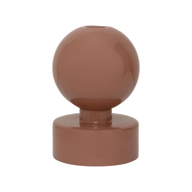 a brown plastic object on top of a white background