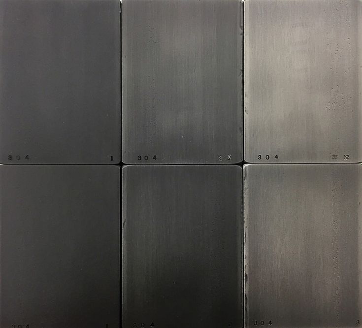 four square metal panels with numbers on each one in black and silver color, set against a white background