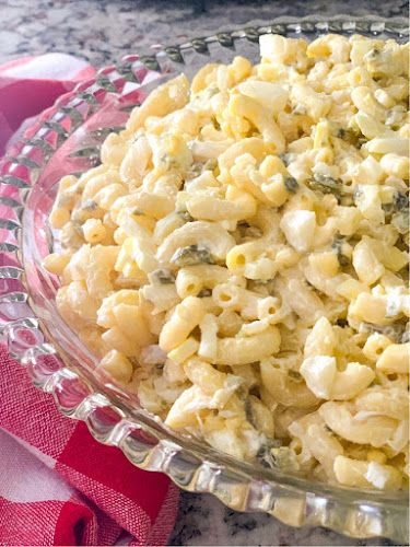 a bowl filled with macaroni and cheese on top of a table