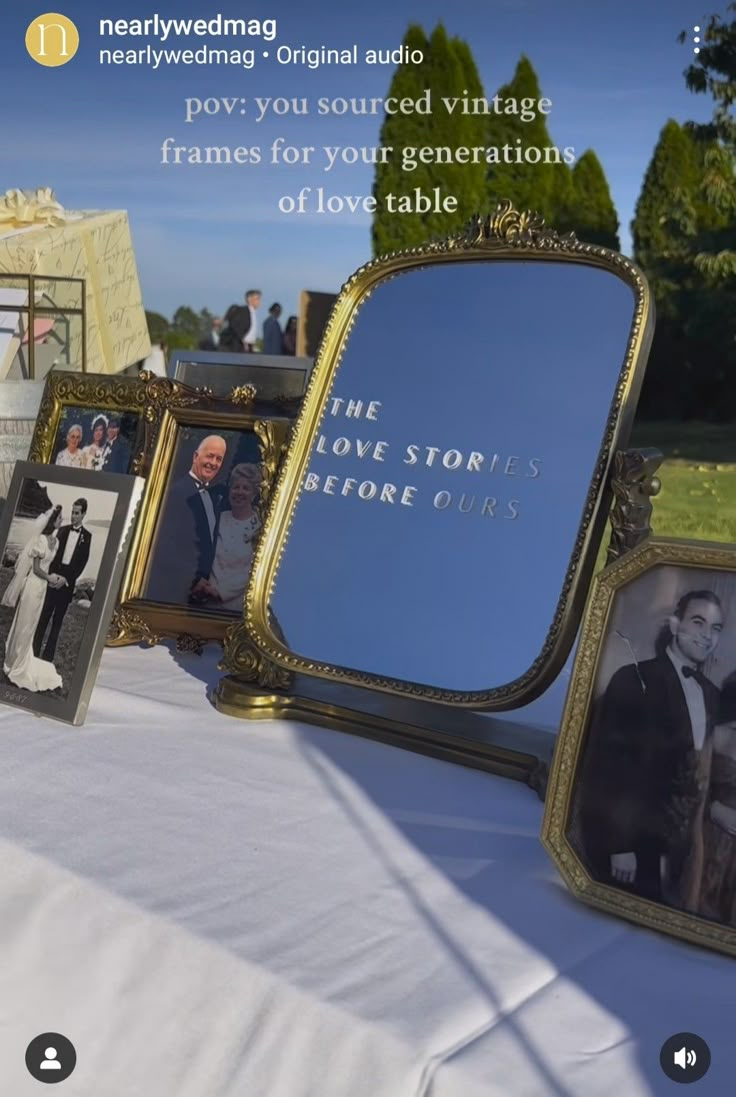 there is a table with pictures on it and an old fashioned mirror in the middle