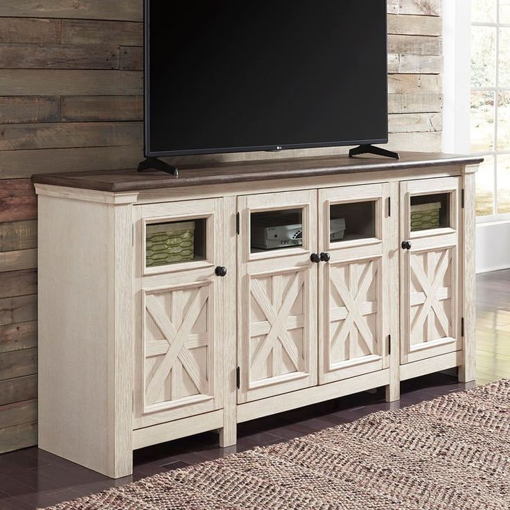 a flat screen tv sitting on top of a wooden cabinet