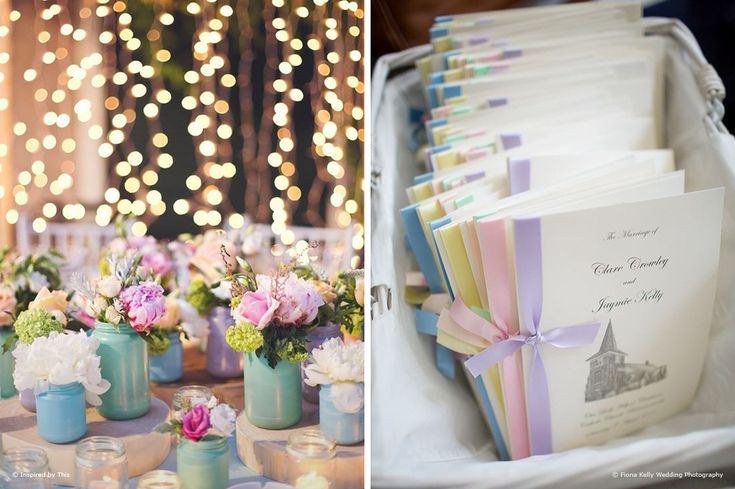 the table is set up with cards and vases filled with flowers, books and other items