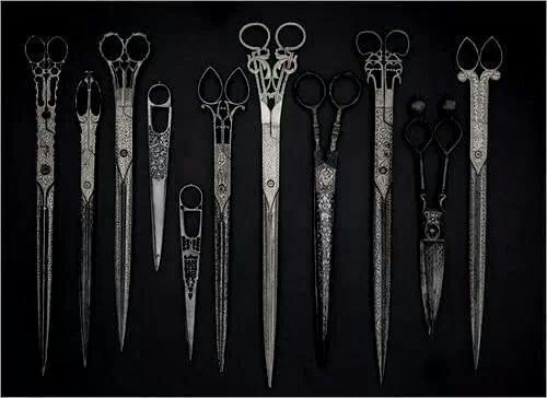 there are many different types of scissors in this picture, but one is black and white