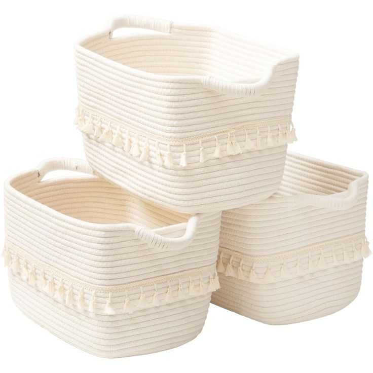 three white storage baskets stacked on top of each other