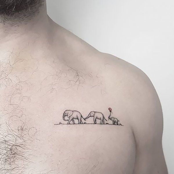 an elephant and giraffe tattoo on the back of a man's chest