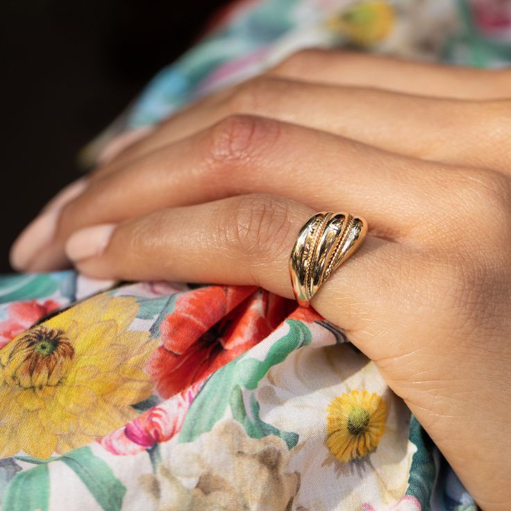 The Story A chic vintage ring made during the mid-to-late 20th century. Constructed from warm 14 karat yellow gold, a minimalist design of three tiers stack and move across the finger. Roped detailing is seen between the tiers giving the ring texture. The dome design gives the ring depth and dimension. Substantial in look, its hollowed construction makes it light and easy to wear. Forever a desirable piece, a classic gold ring like this is as chic they come. It's a forever jewelry staple and loo Gold Timeless Bypass Ring For Anniversary, Timeless 14k Gold Midi Rings For Anniversary, Timeless Gold Bypass Ring For Anniversary, Vintage Yellow Gold Midi Rings For Wedding, Gold Stackable Bypass Ring In Fine Jewelry Style, Anniversary Stackable Gold Bypass Ring, Classic Yellow Gold 14k Bypass Ring, Classic 14k Gold Bypass Ring, Elegant 14k Stamped Midi Rings For Anniversary