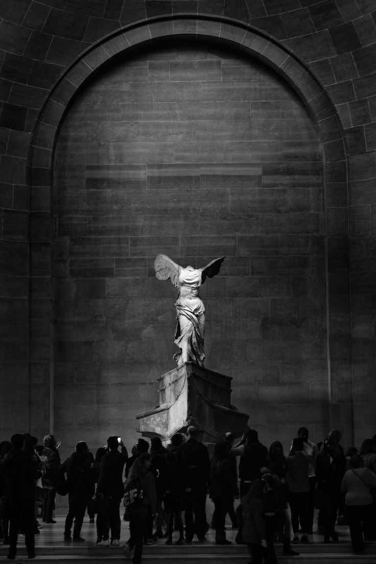 the statue is surrounded by people in black and white