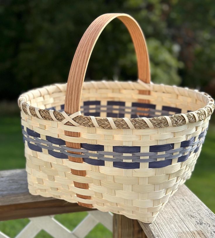 a woven basket sitting on top of a wooden bench