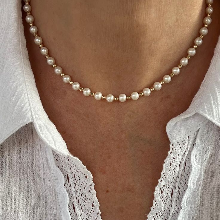 This pearl necklace is handcrafted with AAA+ quality 6mm white round freshwater pearls and small 14k gold filled spacer beads. The pearls have a high luster and iridescence, are perfectly calibrated and are uniform in size. This ultra contemporary modern necklace is simple and attractive, perfect for day or night. The bracelet that matches the necklace is found HERE: https://www.etsy.com/listing/1438218194/round-pearl-and-14k-gold-bracelet-white?click_key=febd606be4d264d89a9d130fc5d305b2021a504f Pearl Necklace With Round Beads And Pearl Charm, Everyday Single Strand Pearl Necklace With Round Beads, Everyday Single Strand Pearl Necklace, Dainty Round Bead Pearl Necklace, Elegant Everyday Beaded Pearl Necklace, Dainty Pearl Necklace With Round Beads And Charm, Everyday White Single Strand Pearl Necklace, Pearl Necklaces With 8mm Beads For Gifts, Everyday Pearl Necklaces With Round Beads