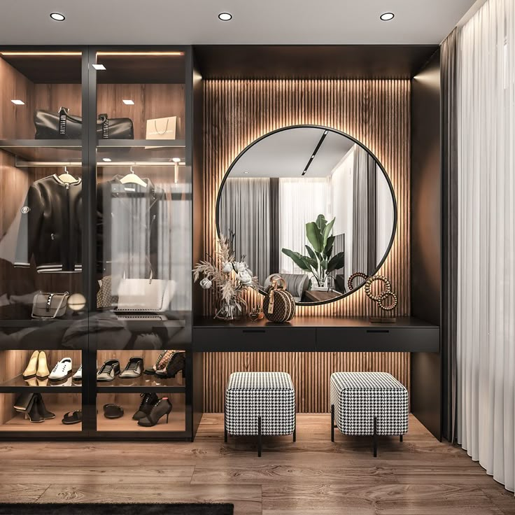 a walk in closet that has a mirror on the wall above it and two stools next to it