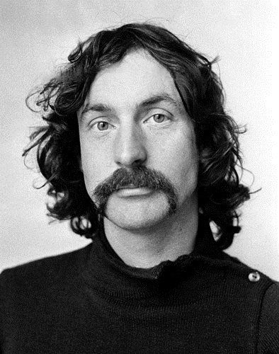 a black and white photo of a man with long hair wearing a turtle neck sweater