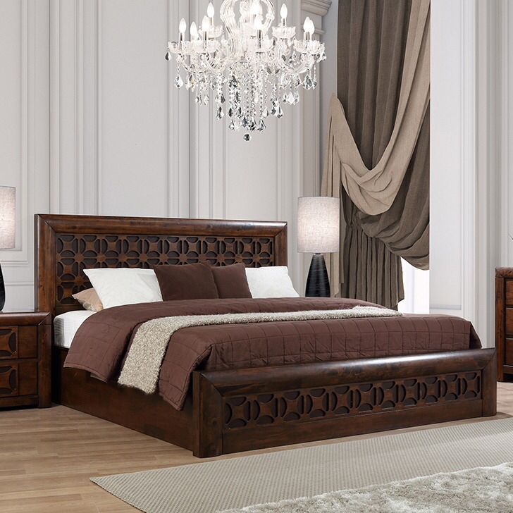 a bed room with a neatly made bed and a chandelier