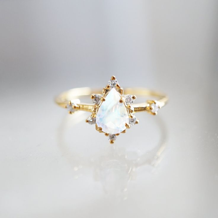 In rose gold, size 6! Moonstone Crush Ring Ethereal 14k Gold Jewelry As A Gift, Ethereal 14k Gold Jewelry For Gifts, Elegant Stackable Topaz Ring For Weddings, Elegant Stackable Topaz Wedding Ring, Timeless Yellow Gold Moonstone Ring, Timeless Gold Stackable Rings With Birthstone, Gold Cluster Ring With Gemstone In Sterling Silver, Dainty 14k Gold Cluster Ring With Gemstone, Gold Opal Promise Ring In Fine Jewelry Style