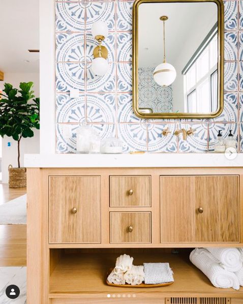 a bathroom with a wooden cabinet and mirror