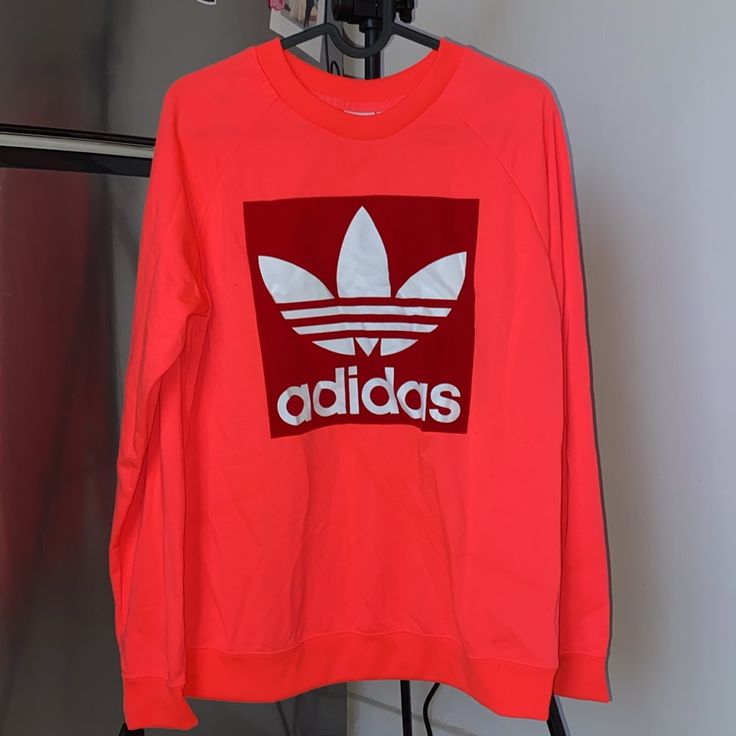 Sweatshirt Color Is Accurate In Covershot. Runs Medium/Large. Adidas Logo Is Red Felt Material. Polyester. Red Oversized Crew Top, Oversized Red Crew Neck Top, Red Athleisure Top With Logo Print, Trendy Red Sweatshirt For Spring, Red Long Sleeve Athleisure Top, Red Sporty Crew T-shirt, Orange Sporty Sweatshirt With Graphic Print, Orange Graphic Print Sporty Sweatshirt, Sporty Orange Sweatshirt With Graphic Print