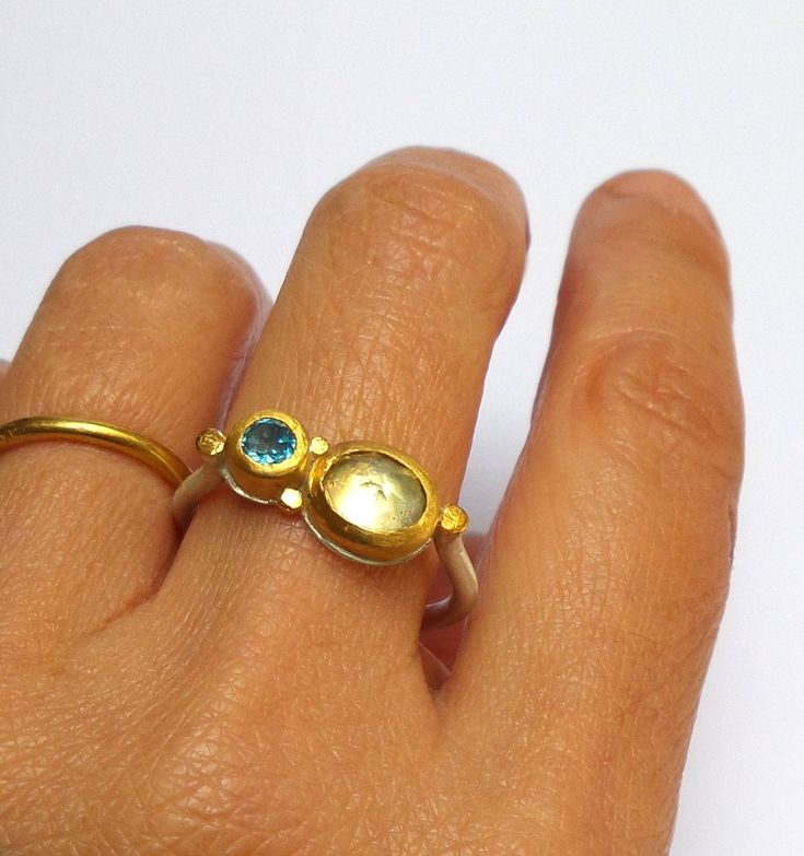 Citrine and Blue Topaz ring- Beautiful Citrine and Blue Topaz ring wrapped with 24 k solid gold decorated with 24 k gold dots . Round sterling silver band 2 mm wide in Matte finish. The Citrine stone size is 7/9 mm. The Blue Topaz stone size is 5 mm. The ring size is 9.5 US /61 U. The ring will be packed in a Beautiful gift box . Free Shipping!! Your item will be shipped via registered air mail with tracking number. Please contact me with any questions or requests. Noga Yellow Gold Sapphire Open Ring In Unique Style, Yellow Gold Sapphire Ring With Open Ring Style, Unique Oval Yellow Gold Topaz Ring, Gold Fusion Rings With Birthstone, Gold Fusion Style Rings With Birthstone, Gold Rings With Birthstone In Modern Style, Gold Jewelry With Rose Cut Diamonds And Blue Topaz, Gift Yellow Gold Topaz Ring, Gold Rings With Birthstone