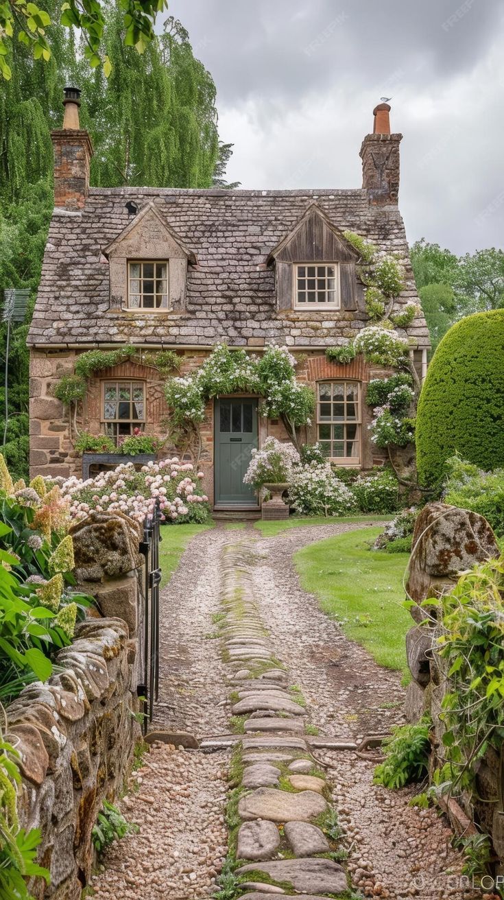 a stone path leading to a brick house with ivy growing on the roof and windows